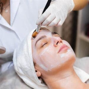 a woman getting a facial mask