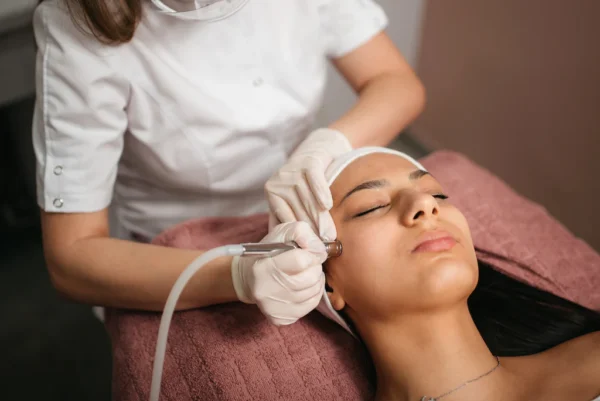 a woman getting a Microdermabrasion treatment on the face